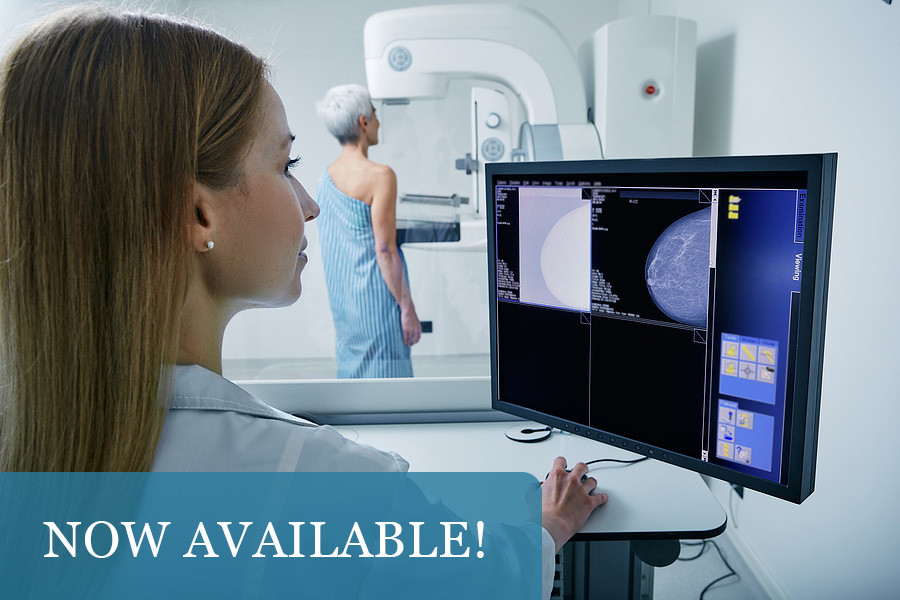 woman looking at mammogram screening machine